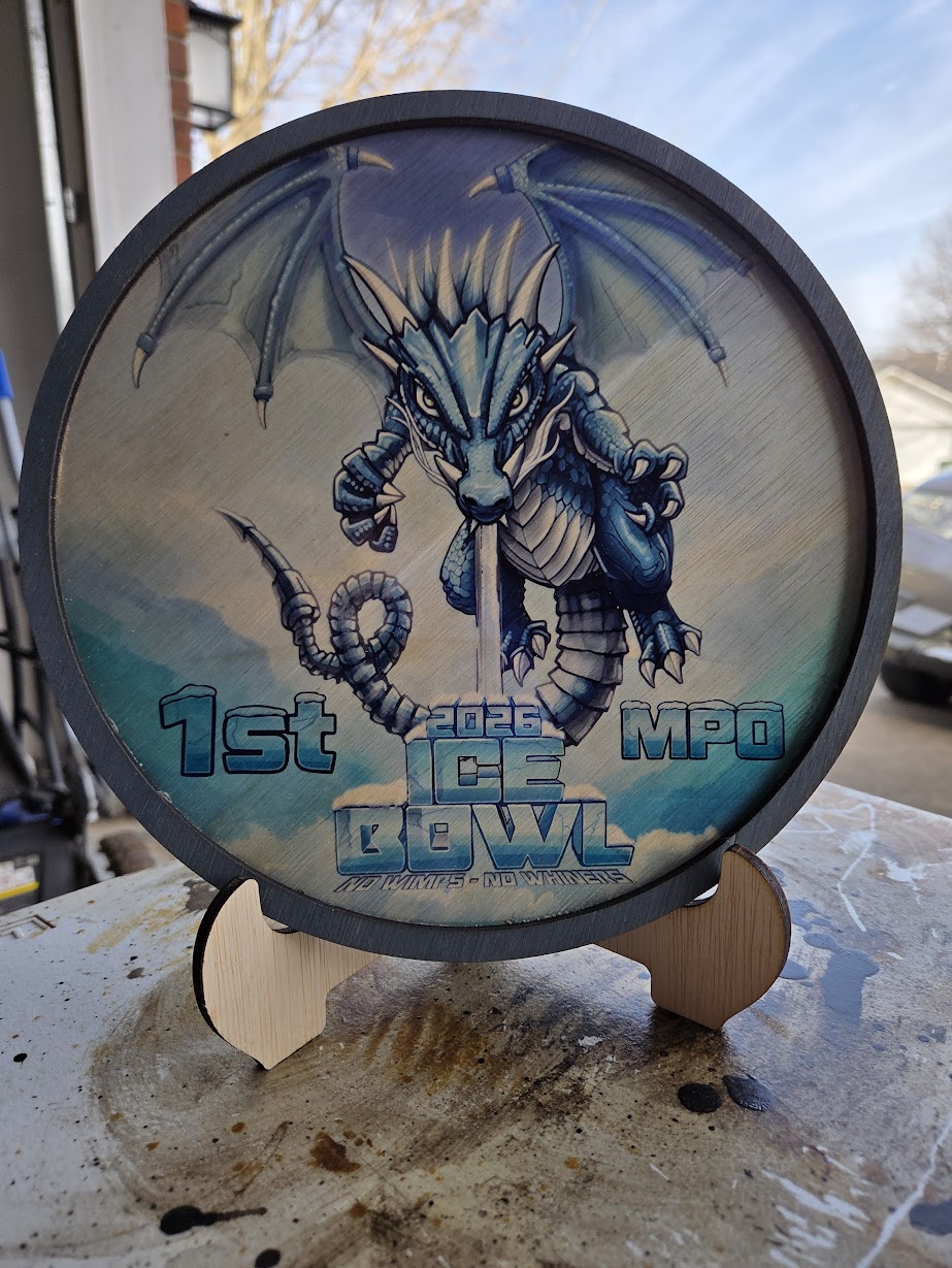 A wooden award with full-color printed artwork